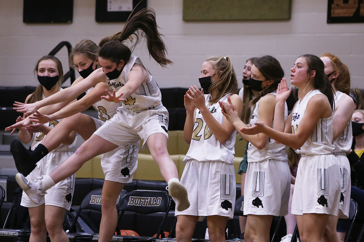 Ava Wagner, left, and freshman Cassidy Bessler jump and touch their toes